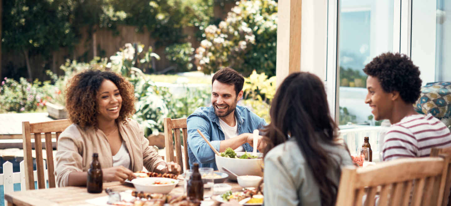 friends eating around a picnic table